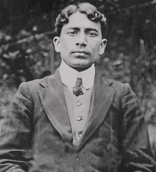 Photographic portrait of Madan Lal Dhingra, head and shoulders, in a dark jacket, waistcoat and high collar.